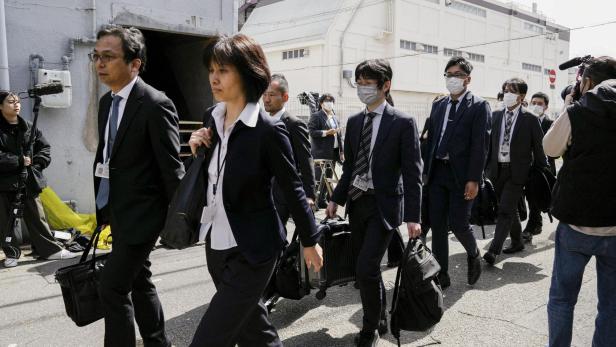 Japanese health ministry officials head to search a Kobayashi Pharmaceutical Co. factory in Osaka