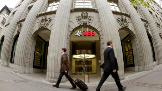 FILE PHOTO: People walk past the headquarters of Swiss bank UBS in Zurich