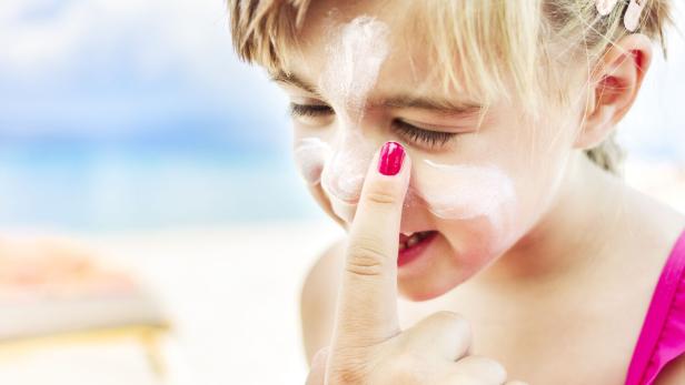 Applying sunscreen to child's face