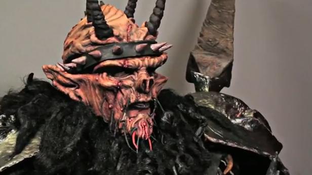 Nahaufnahme eines aufwendigen, furchterregenden Dämonenkostüms mit Hörnern und Fell.