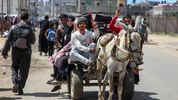 People flee the eastern parts of Rafah after the Israeli military began evacuating Palestinian civilians ahead of a threatened assault on the southern Gazan city