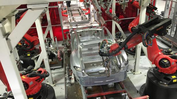 FILE PHOTO: Tesla vehicles are being assembled by robots at Tesla Motors Inc factory in Fremont