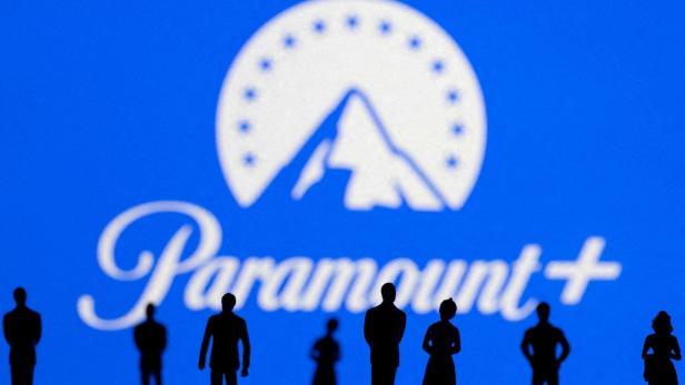 FILE PHOTO: Toy figures of people are seen in front of the displayed Paramount + logo, in this illustration