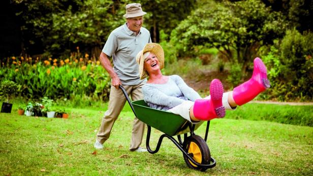 Close,Up,Of,Happy,Senior,Couple,Playing,With,A,Wheelbarrow