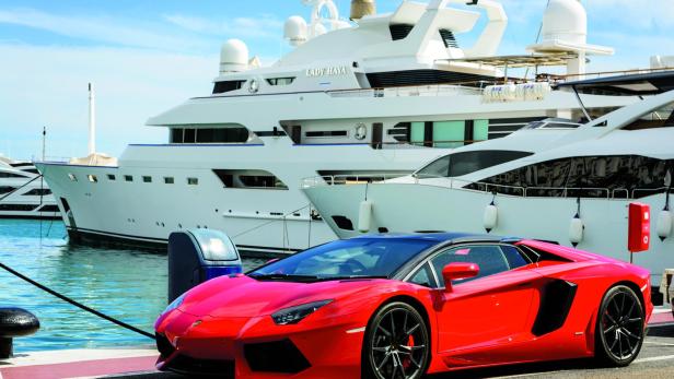 Luxury sports car and yachts at Puerto Banus in Marbella