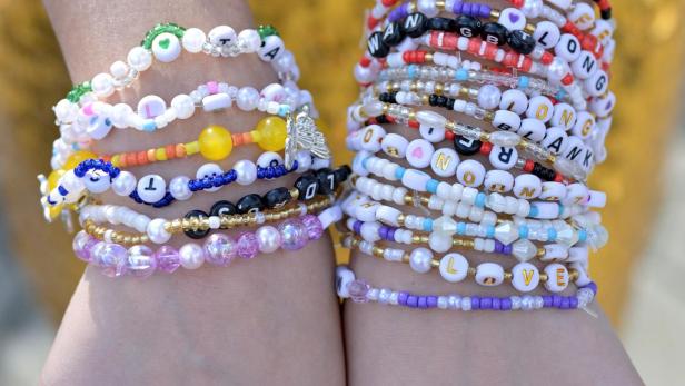 Taylor Swift's fan, Heart Ballado, 28, from Cebu City in Philippines poses with her friendship bracelets at the National Stadium on the first night of Taylor Swift's Eras Tour concert in Singapore