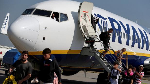 FILE PHOTO: Passengers alight from a Ryanair aircraft at Ferenc Liszt International Airport in Budapest