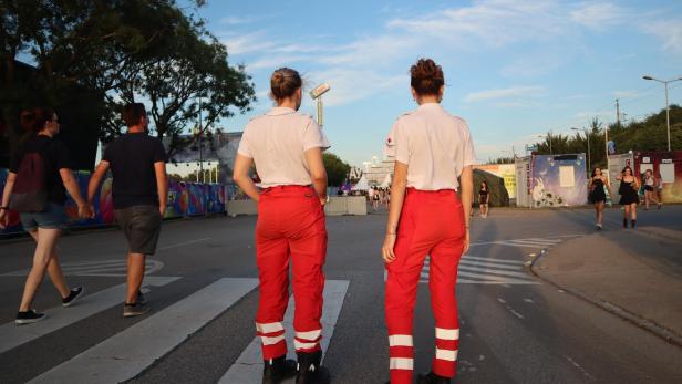 Zwei Frauen in Rot-Kreuz-Uniform stehen vor dem Frequency-Gelände.