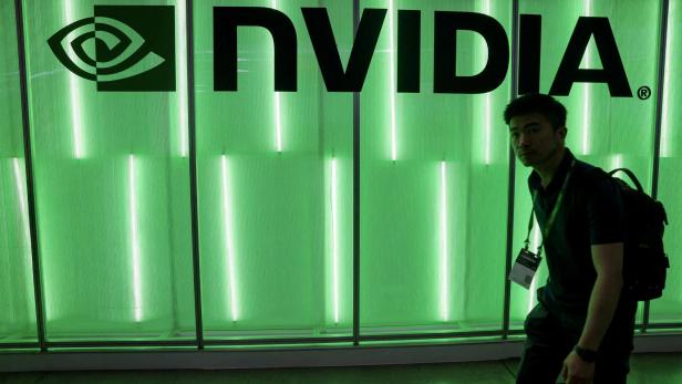 FILE PHOTO: A person walks pass a Nvidia logo at Computex in Taipei