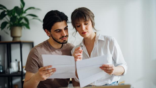 Worried Couple Paying Bills at Home