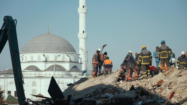 Rescue workers are seen at Trend Garden Residence, following a deadly earthquake, in Malatya