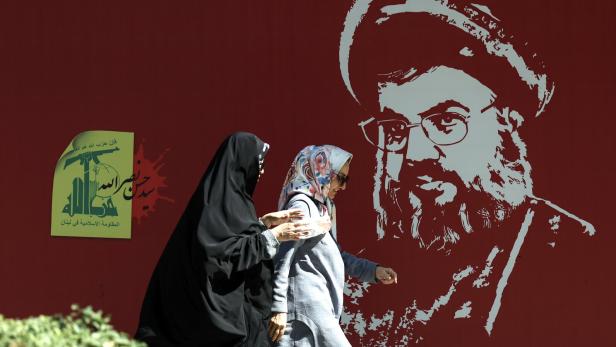 Iranische Frauen vor einem Porträt des verstorbenen Hisbollah-Anführers Hassan Nasrallah, das in einer Straße in Teheran aufgestellt wurde