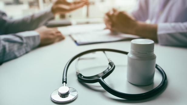 Close up stethoscope and doctor talking the patient at clinic while using the tablet explaining the patient condition and the treatment result.