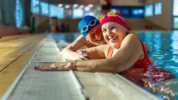 Zwei ältere Freunde hängen zusammen im Schwimmbad ab.