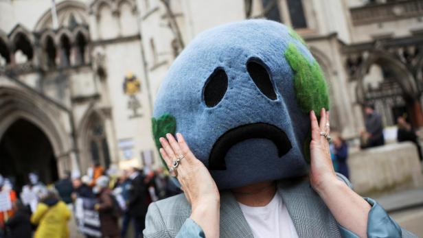 Climate activist demonstrates outside the high court in London