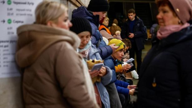 People take shelter inside a metro station during a Russian missile attack, in Kyiv