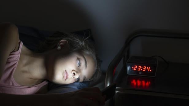 Girl using her smartphone late at night