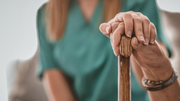 Caregiver's hand on elder's hand