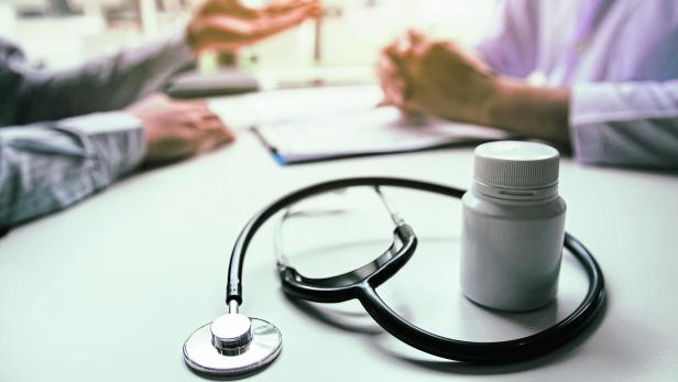 Close up stethoscope and doctor talking the patient at clinic while using the tablet explaining the patient condition and the treatment result.