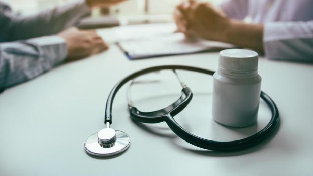 Close up stethoscope and doctor talking the patient at clinic while using the tablet explaining the patient condition and the treatment result.