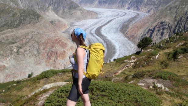 Frau steht vor dem Aletschgletscher