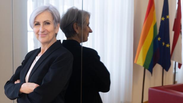 Justizministerin Anna Sporrer posiert selbstbewusst lächelnd.
