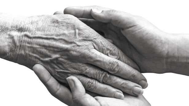 Young hands holding old woman hand isolated Young hands holding old woman hand isolated