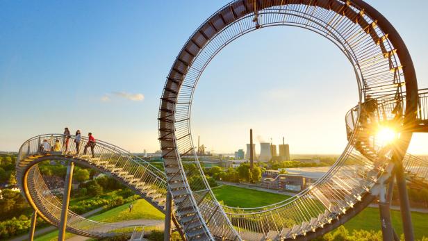Eine Achterbahn, auf der sich Menschen zu Fuß bewegen.