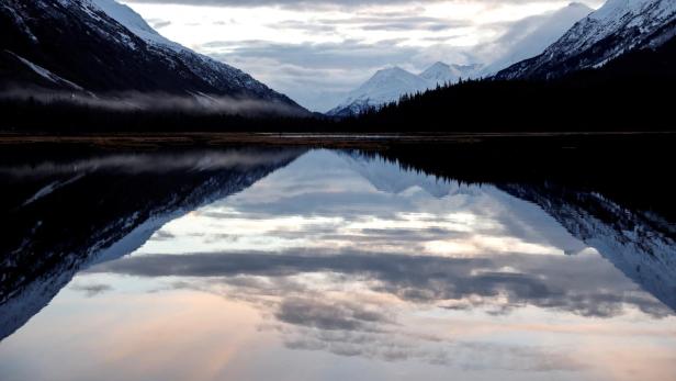 FILE PHOTO: Snow capped mountains are reflected in Kenai Lake outside of Cooper Landing in Anchorage