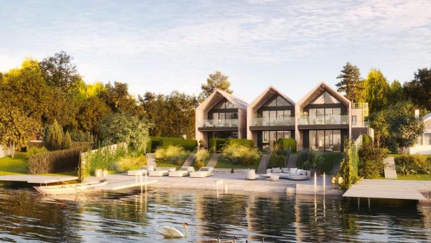 Am Neufelder See entstehen gerade sechs Luxus-Wohnungen mit Zugang zum Wasser. Drei Luxus-Reihenhäuser stehen an einem See.