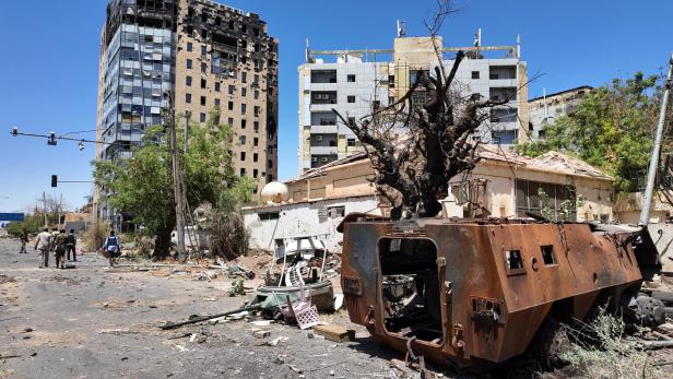 Members of army walks next to destroyed military vehicle and bombed buildings in the state of Khartoum Khartum ist in der Hand der Regierung, doch die massive Zerstörung wird noch lange zu sehen sein