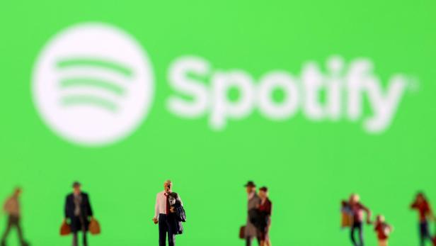 FILE PHOTO: Illustration shows small figurines and displayed Spotify logo FILE PHOTO: Illustration shows small figurines and displayed Spotify logo