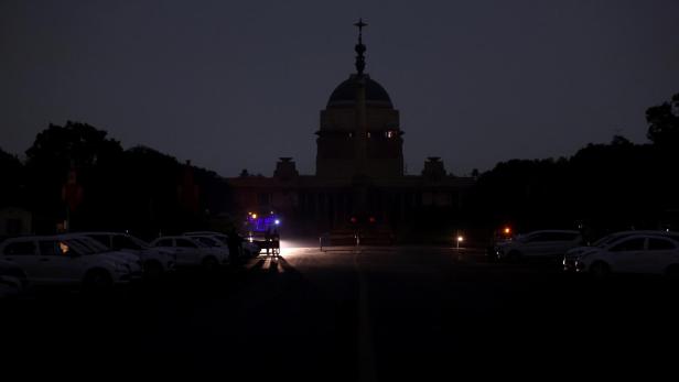 A vehicle passes by during a power blackout as part of a security mock drill near Rashtrapati Bhawan in New Delhi A vehicle passes by during a power blackout as part of a security mock drill near Rashtrapati Bhawan in New Delhi