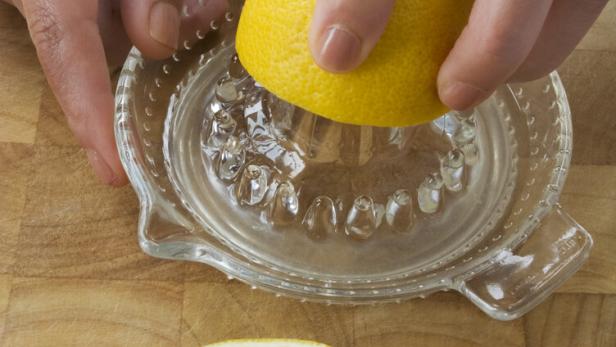 Squeezing lemon juice.