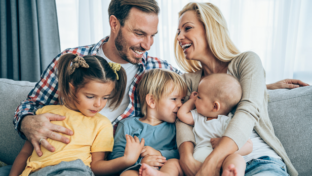 Familie mit 3 Kindern auf Sofa