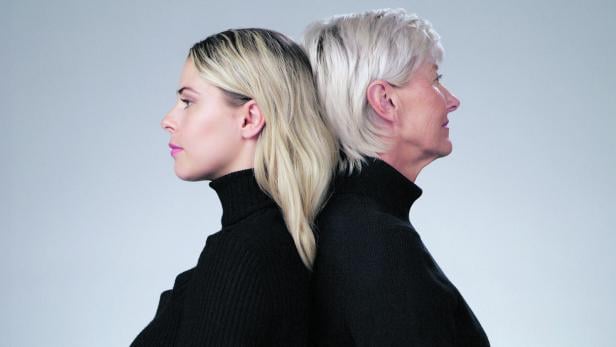 Serious, fashion and profile of mother and daughter isolated on a grey studio background. Back to back and strong senior mom with a girl looking stylish, fashionable on a backdrop