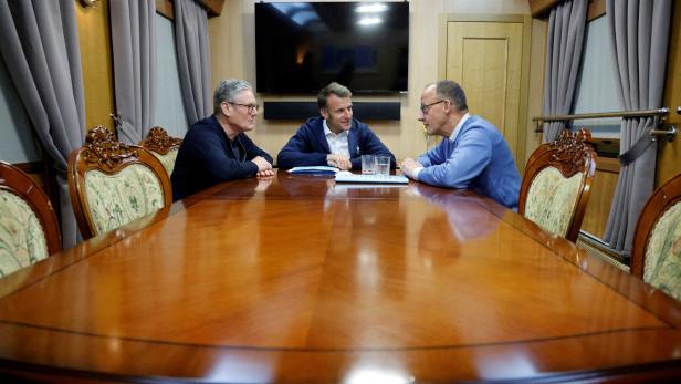 France's President Emmanuel Macron, Britain's Prime Minister Keir Starmer and German Chancellor Friedrich Merz hold a trilateral meeting on board a train to Ukraine