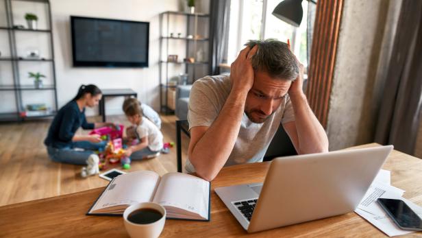 Unhappy man feel distressed working on laptop at home