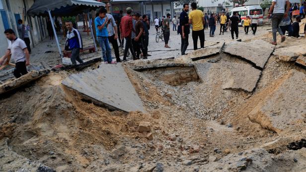 Palestinians inspect the damage at the European Hospital, in Khan Younis