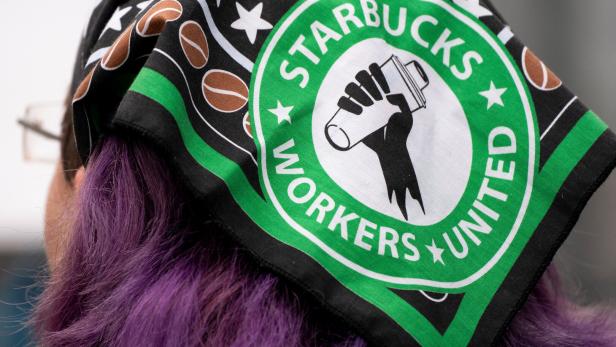 Workers and supporters picket in front of a Starbucks Reserve Roastery in Seattle