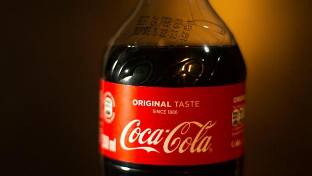 Cola-Flasche steht auf Tisch