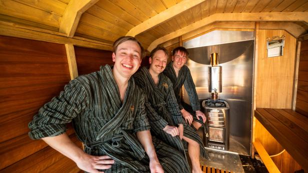 Members of the band KAJ pose in the sauna of the BastutiBasel fan project in Basel