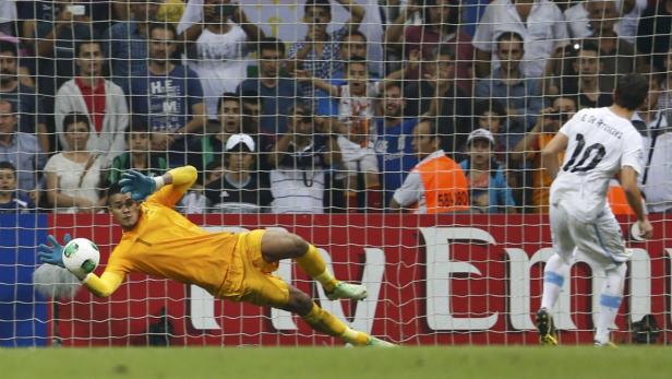 France's Areola saves a penalty shot by Uruguay's