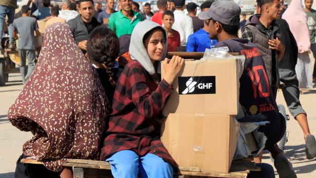 Palestinians seeking aid gather near an aid distribution site run by the U.S.-backed Gaza Humanitarian Foundation, in Rafah