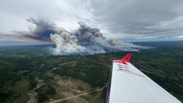 Smoke rises from the Kiskatinaw River wildfire which has prompted evacuation orders in BC