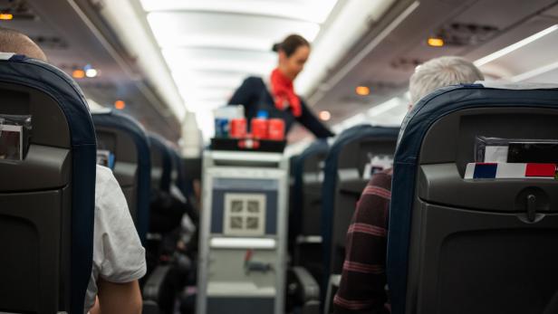 Back view of passengers traveling by airplane. Back view of passengers traveling by airplane.