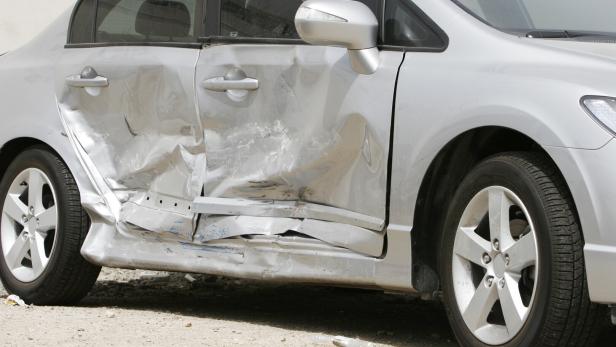 Silver car with a large dent in the side, ruining two doors Silver car with a large dent in the side, ruining two doors