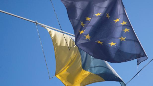 FILE PHOTO: Flag of EU flies next to Ukraine's national flag in Bern