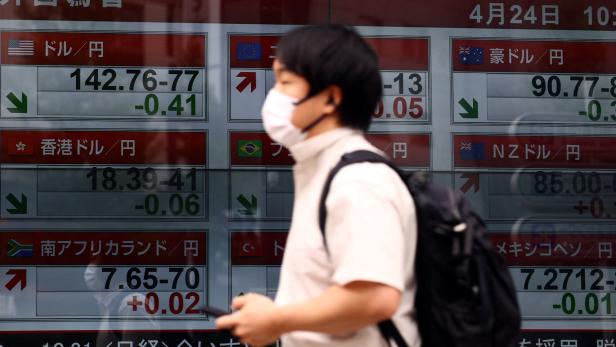 A man walks past an electronic screen displaying exchange rate between Japanese yen and U.S. dollar, and other foreign currencies in Tokyo A man walks past an electronic screen displaying exchange rate between Japanese yen and U.S. dollar, and other foreign currencies in Tokyo