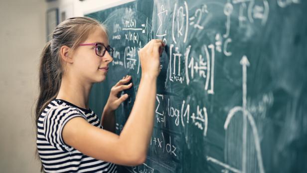 Teenage girl solving advanced mathematical problems